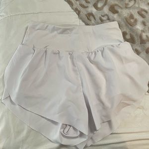 dragon fit, high waisted white tennis shorts.